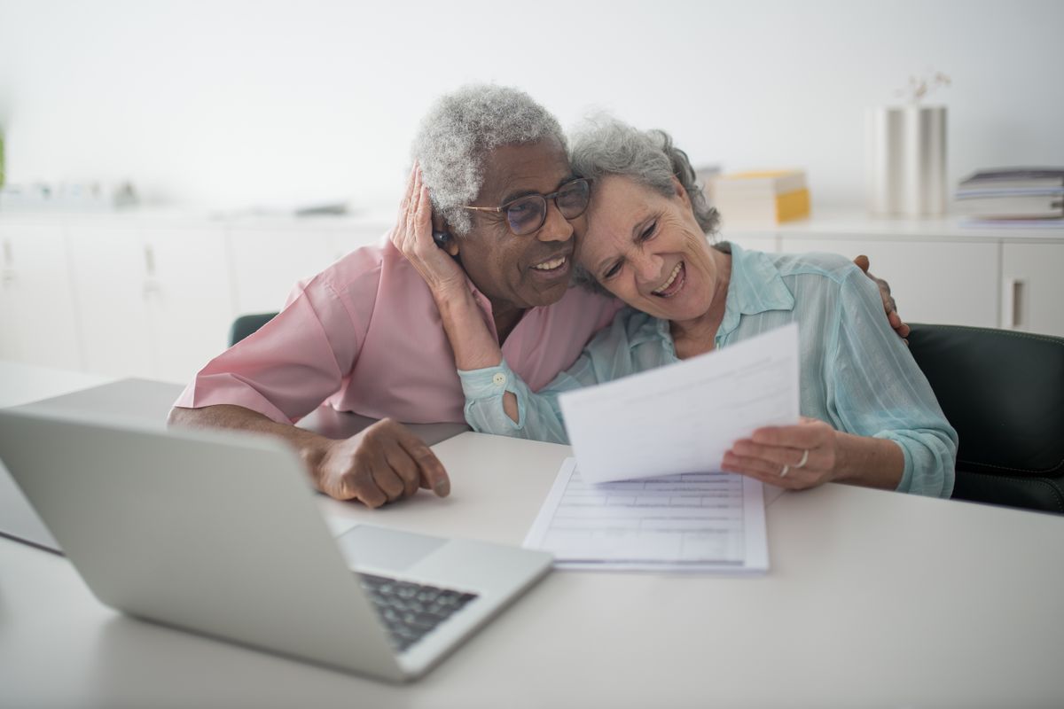 Senior woman reviewing planning documents with a family member